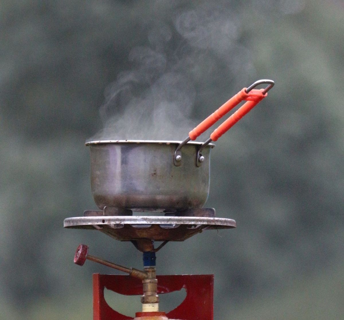 A pot steaming on a gas burner